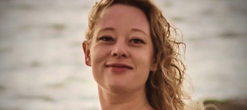 Portrait (headshot) photo of smiling woman on beach. Woman is award-winning US poet Renee Nicole Good